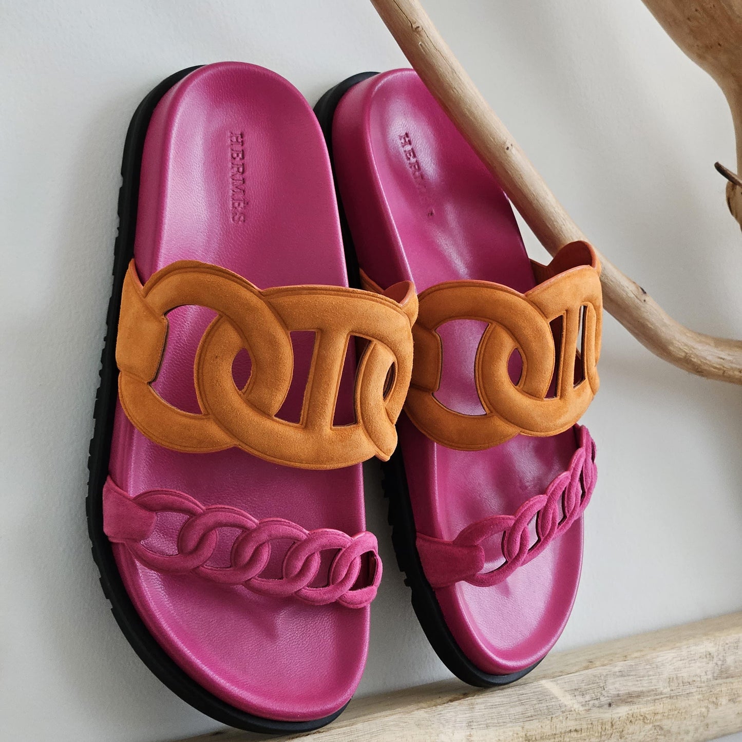 Pink slides with brown chain design on a light background