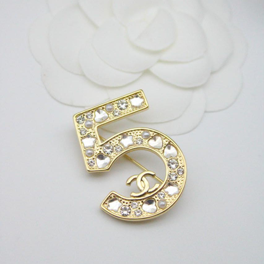 Chanel CC costume brooches