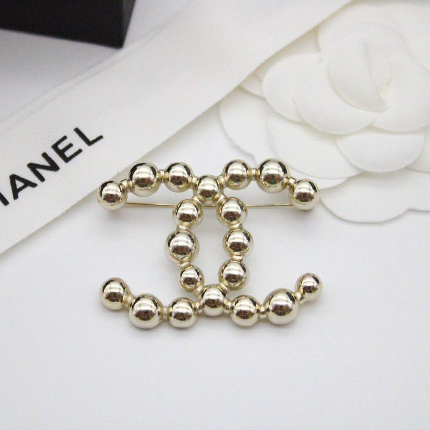 Chanel CC costume brooches